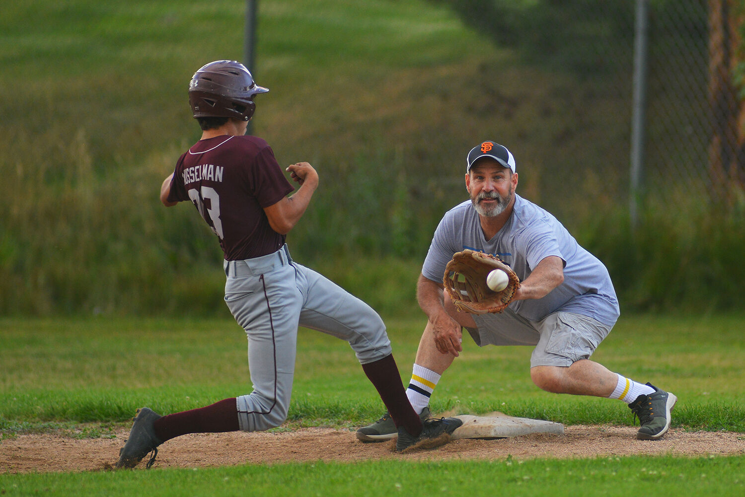 Wes Killian stretches to catch a throw from the pitcher that forced baserunner Joe Musselman back to first